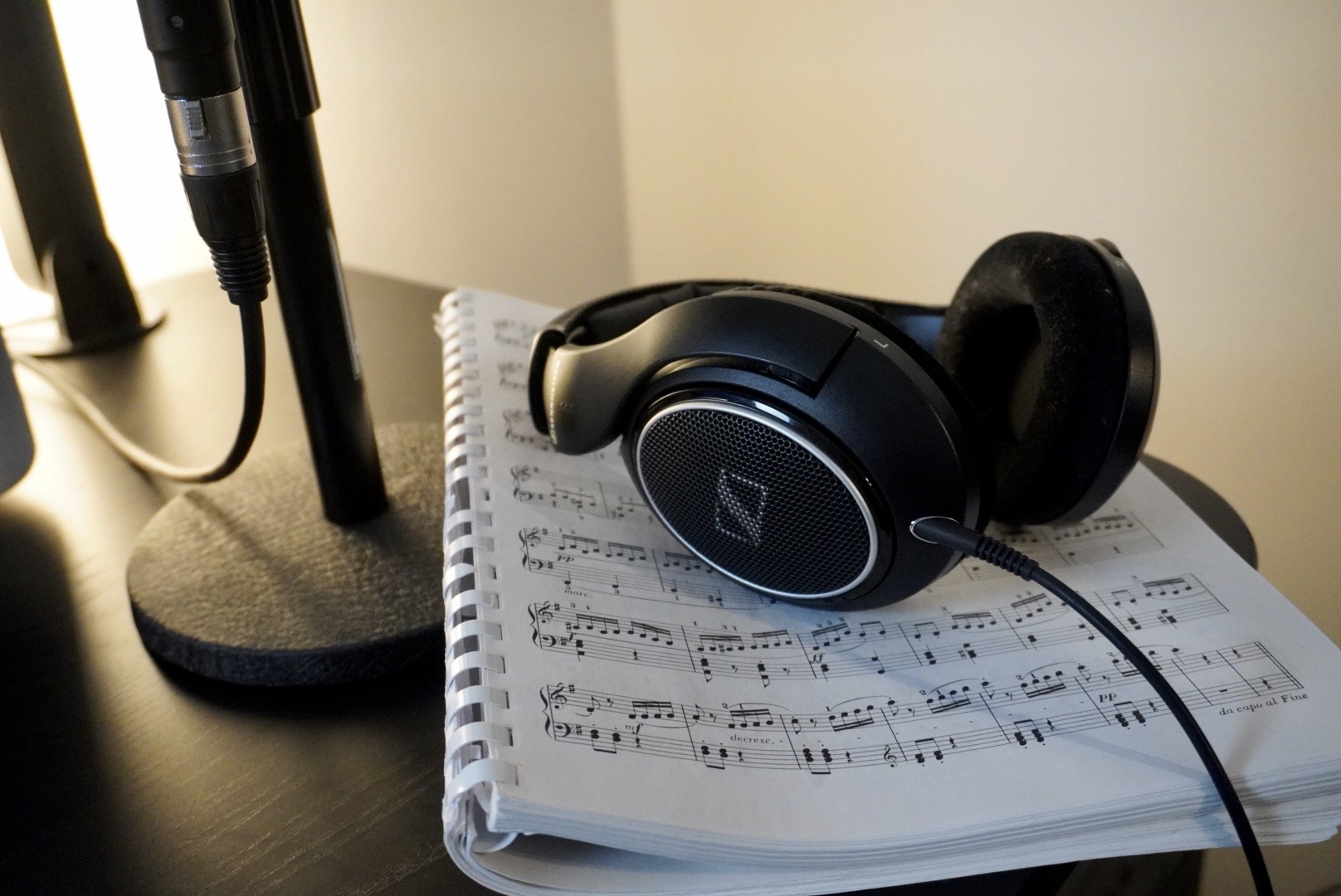 headphones laying on piano sheet music 